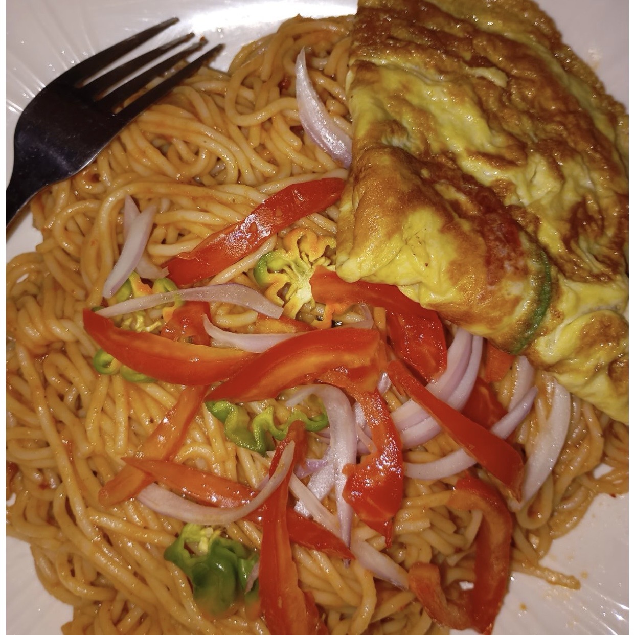 Spicy hot spaghetti with egg and vegetables