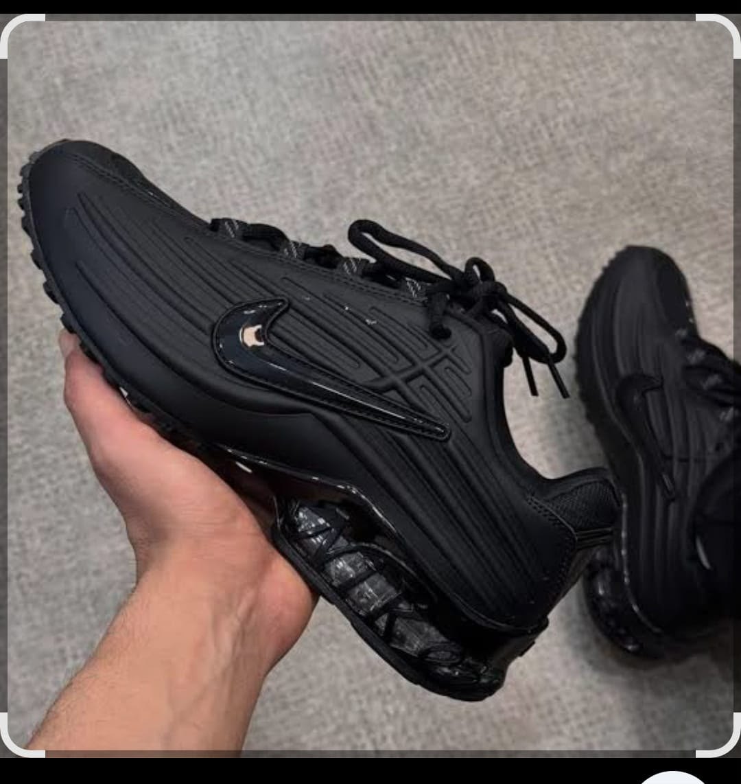 All-black nike sneakers featuring a sleek, ribbed upper, outlined swoosh, and a