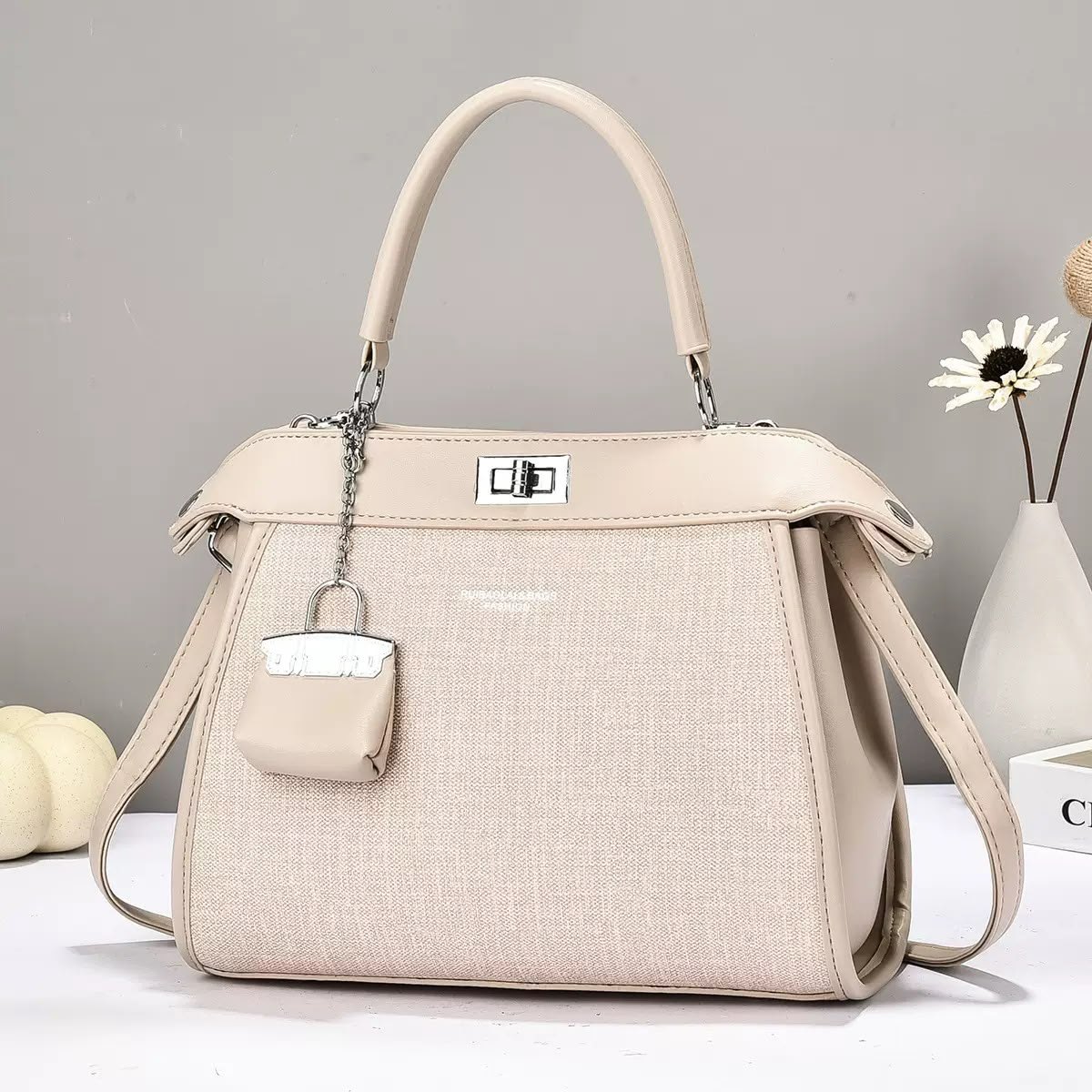 Beige structured handbag with mini charm