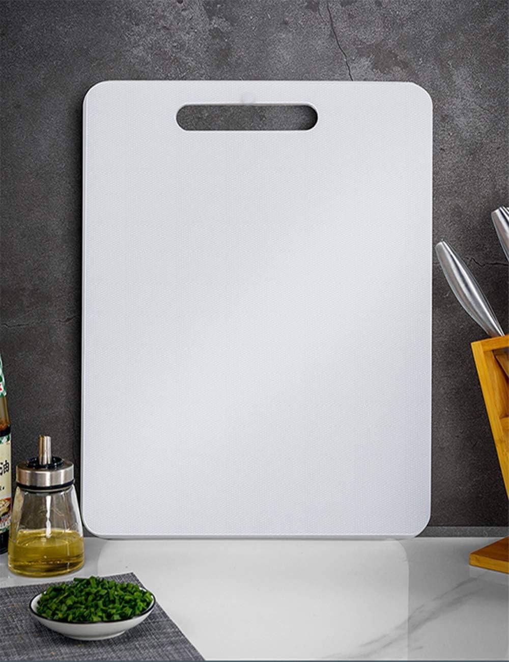 Large white plastic cutting board with handle