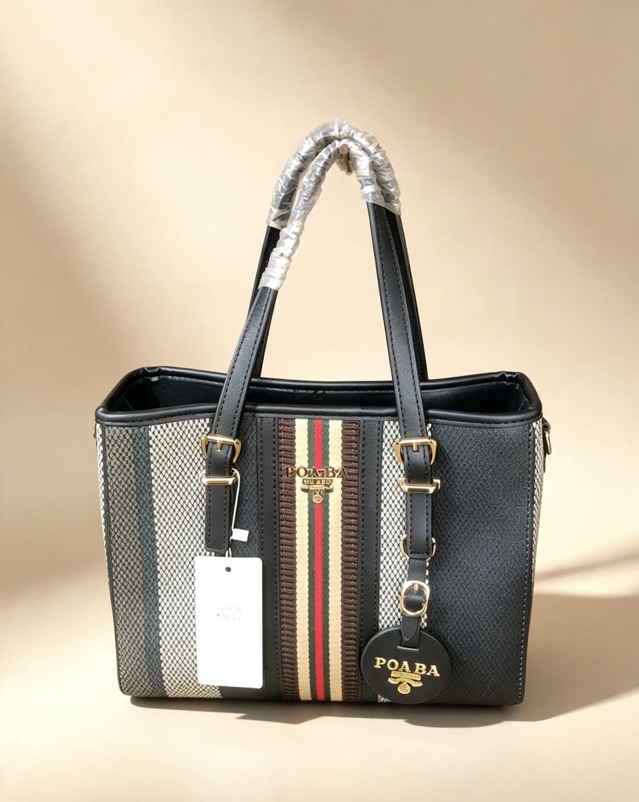 This is a poaba striped canvas & leather-trim tote handbag 💛